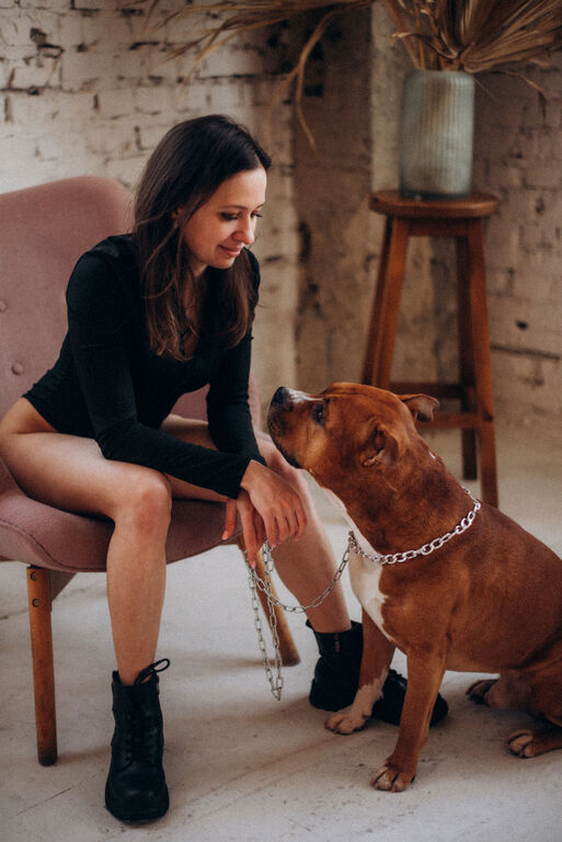 Girl sitting next to Amstaff